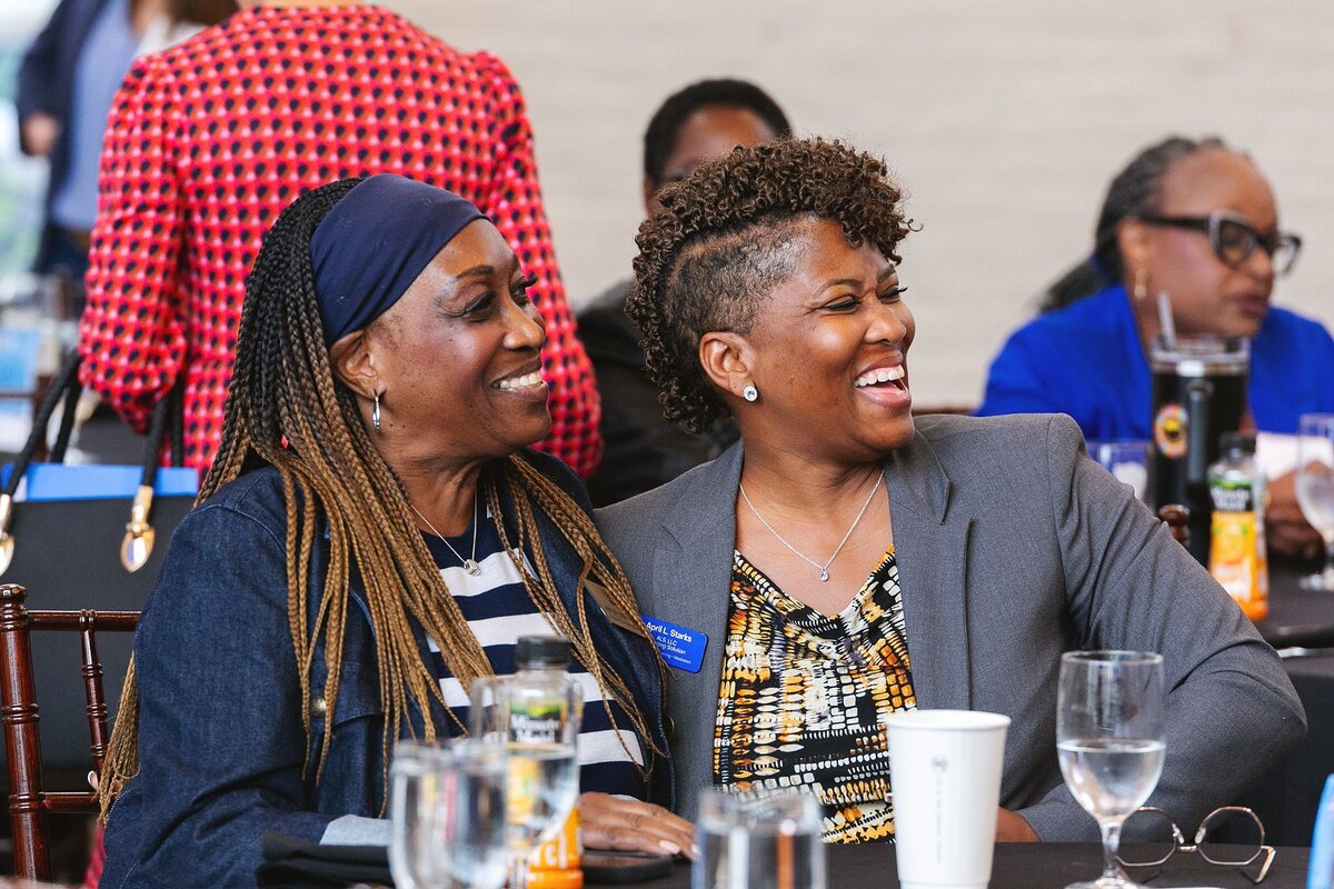  two-professional-women-smiling-and-laughing-while-networking-at-a-business-event-in-carmel-indiana