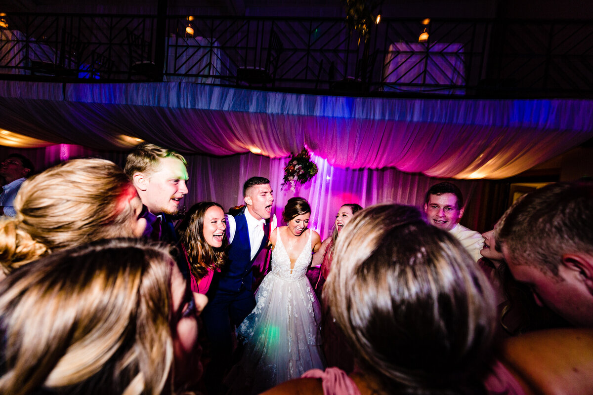 One of the top wedding photos of 2020. Taken by Adore Wedding Photography- Toledo, Ohio Wedding Photographers. This photo is of a bride and groom dancing the night away at Nazareth Hall in Grand Rapids