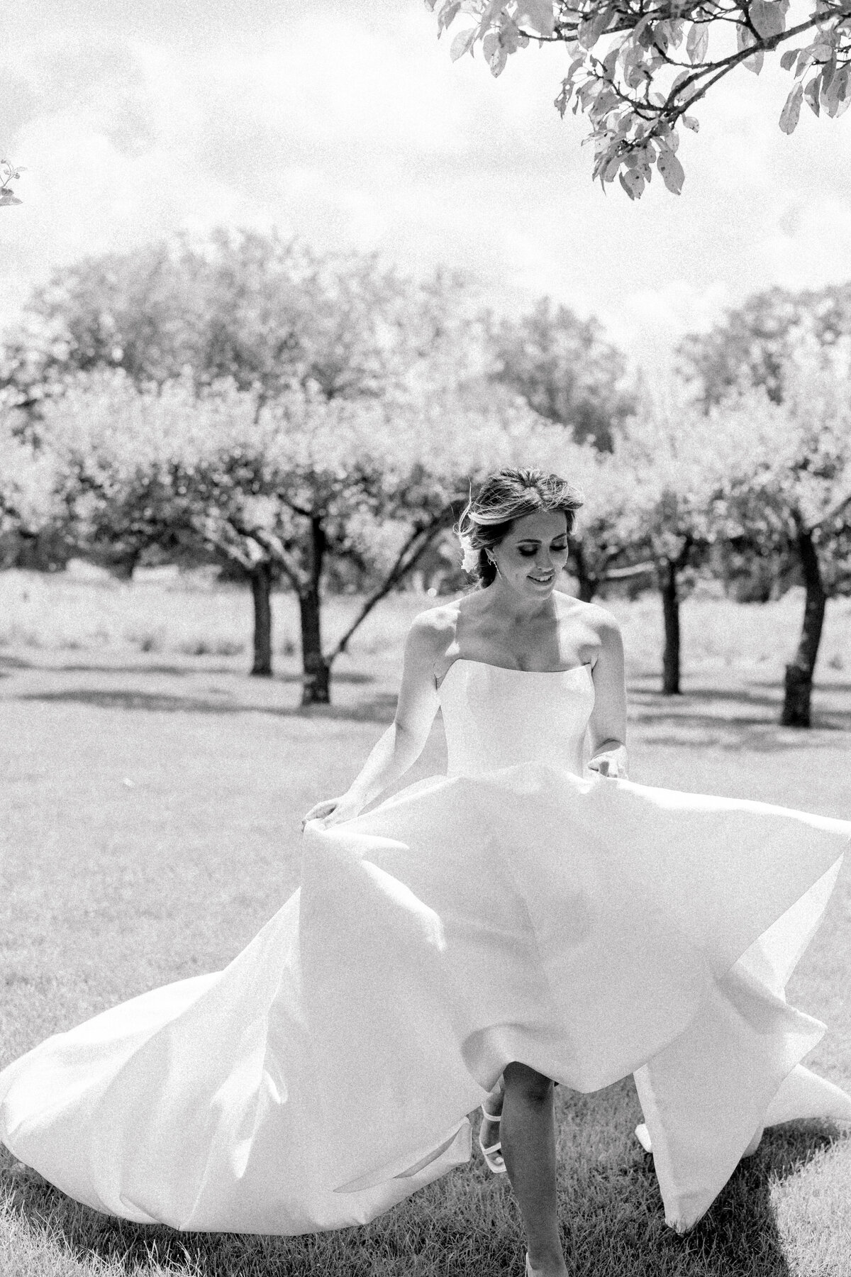 black-and-white-bride-running-shot-smith-farms-garden