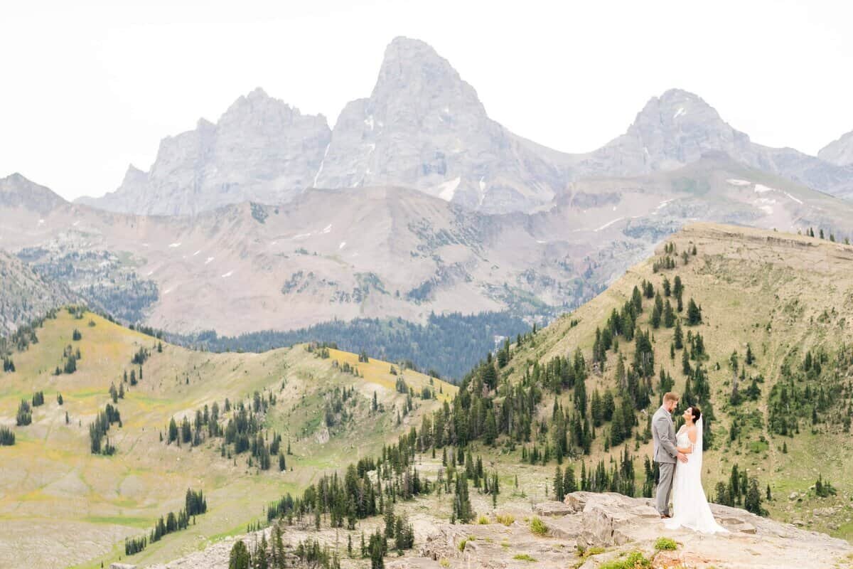 Bride and groom share a kiss on the top of Grand Targhee Ski Resort