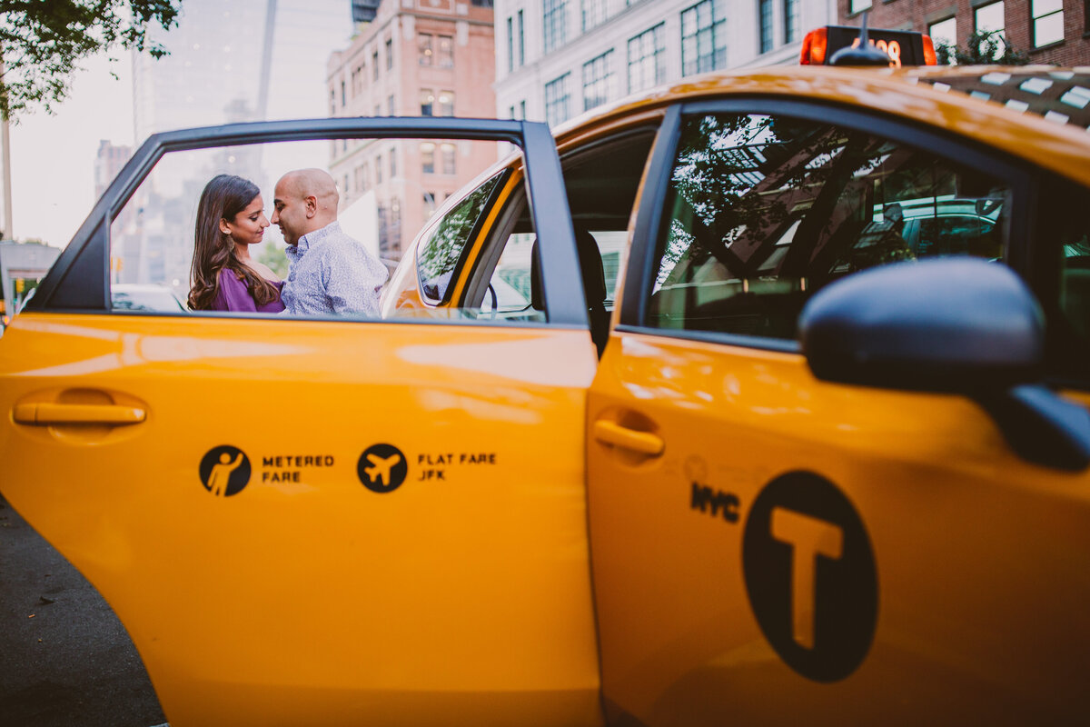 A couple seen sharing a moment through the nyc taxi cab window