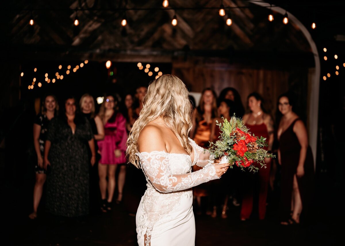bride-throwing-bouquet-at-wedding-reception