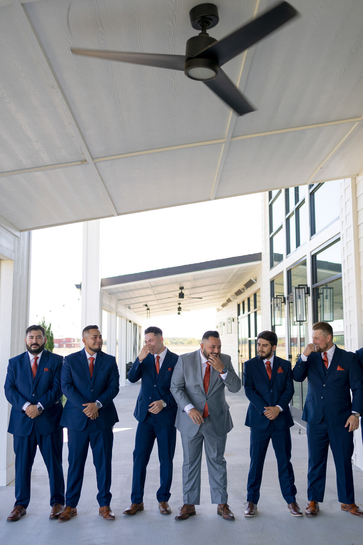 groom with groomsmen in navy suits