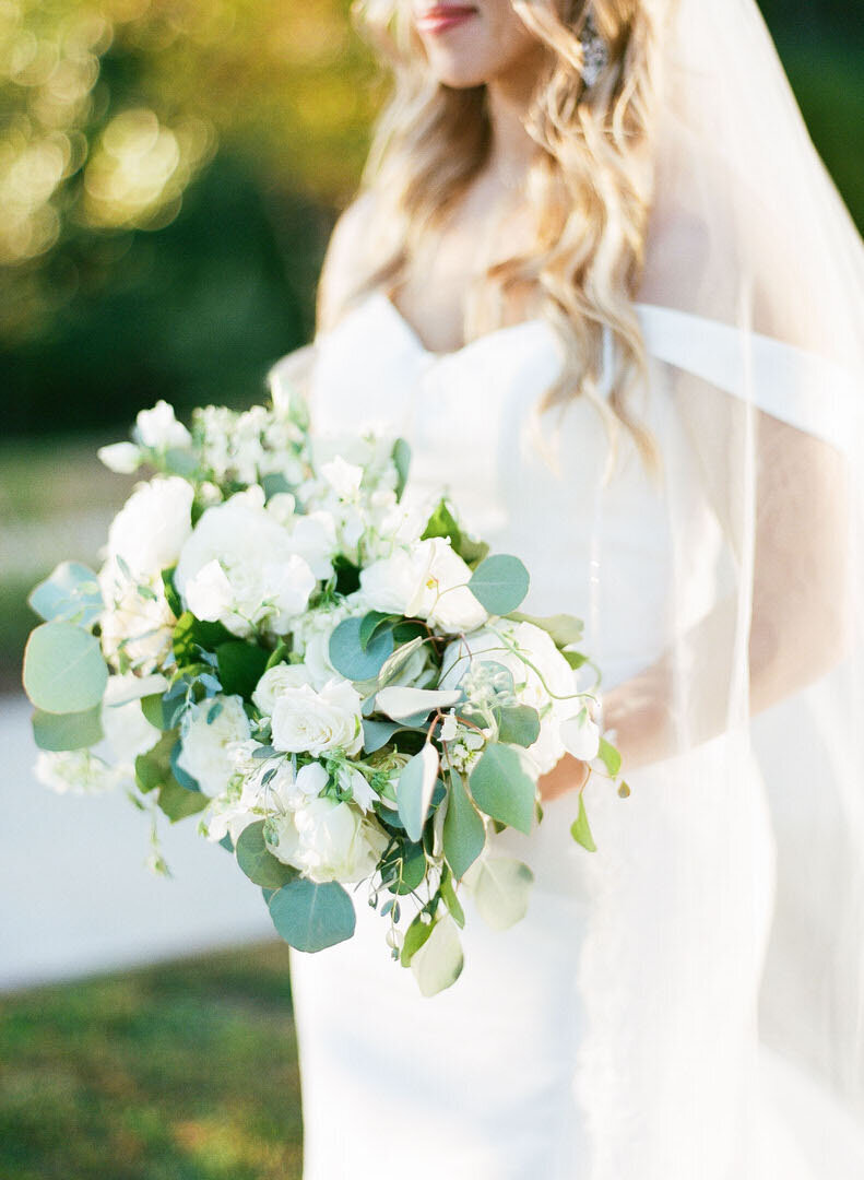 Bride Holding White Bouquet of Flowers Photo