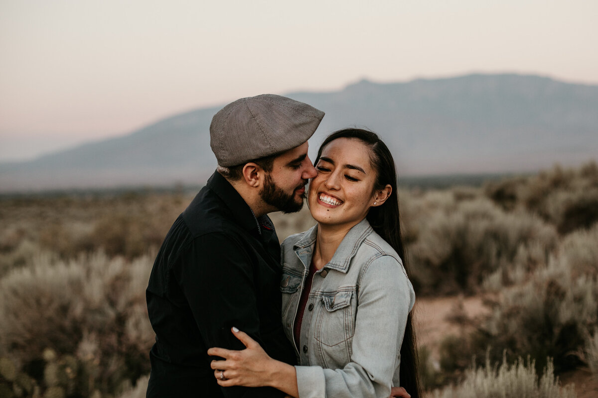 man kissing fiancé's face