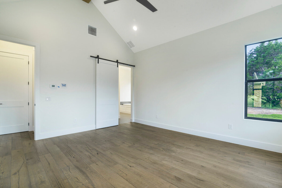 white barn door to bathroom