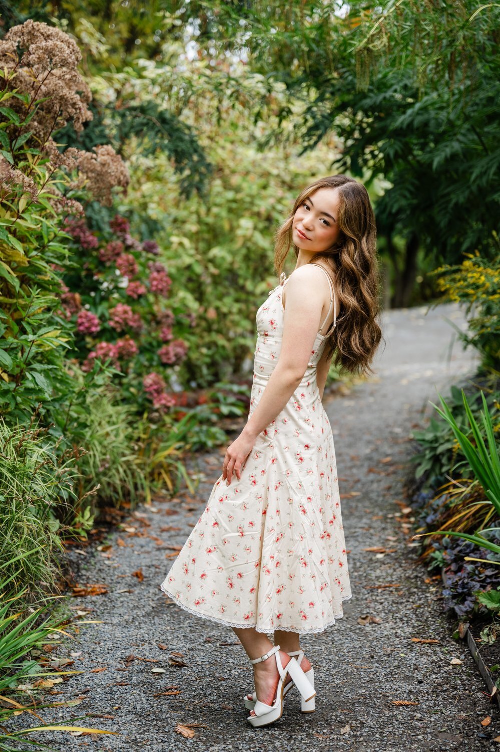 high school senior girl in tea length floral dress