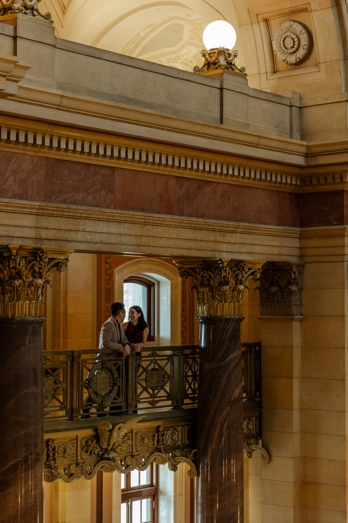 Couple looking at each other from the balcony at the MN State Capitol Building 