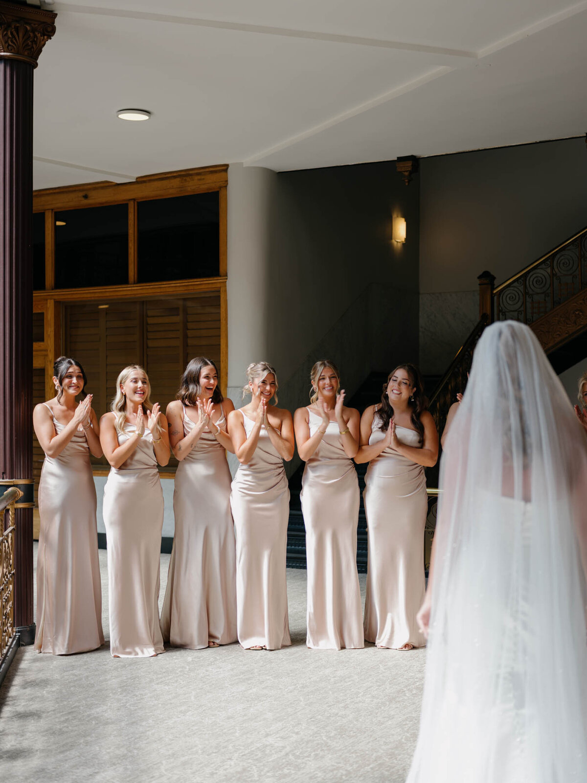 Bridesmaids first look with bride at The Arcade Hyatt Regency Cleveland