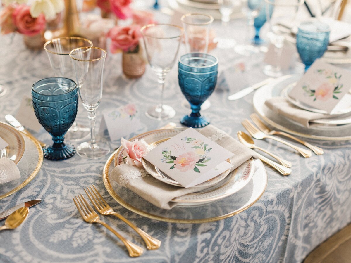 Romantic place setting with gold pink and blue details for wedding