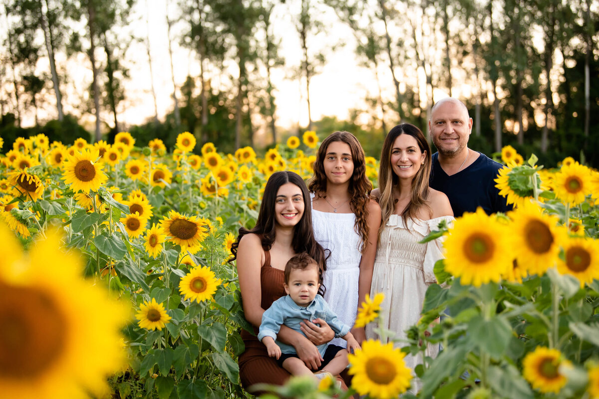 Mom and dad with their two daughters and baby boy for their Burlington sunflower family photographer session