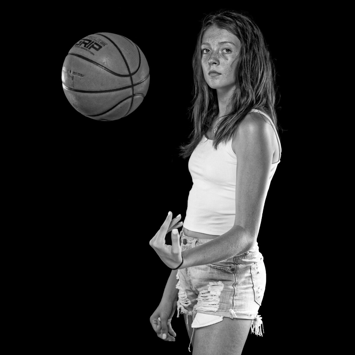 girl throwing basketball black white portrait
