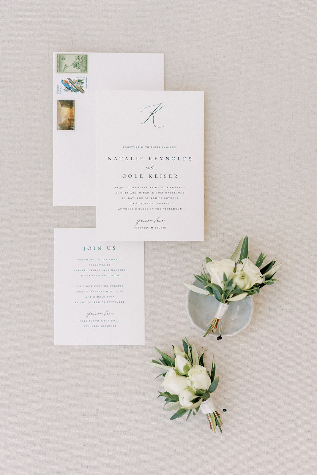 a flat lay of white wedding invitations