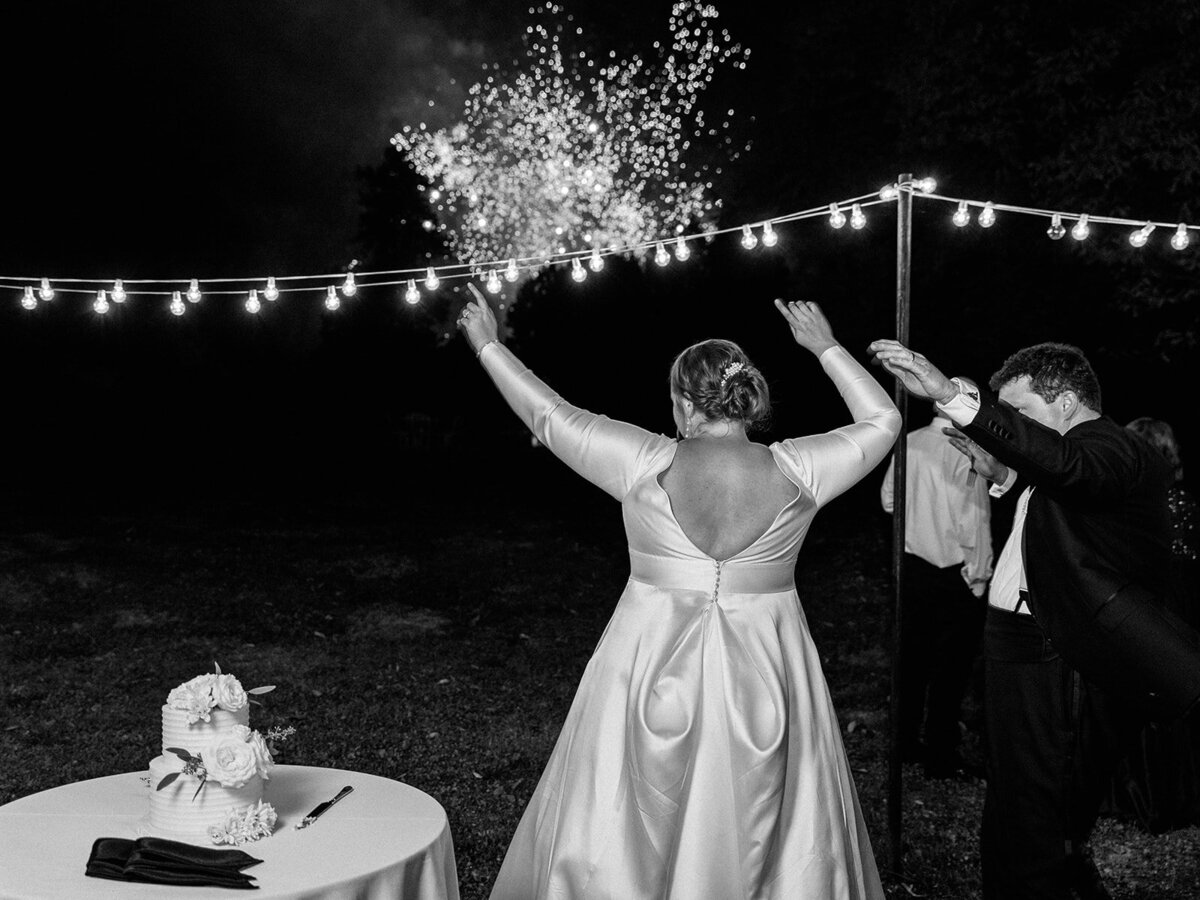 bride and groom celebrate  as fireworks set off