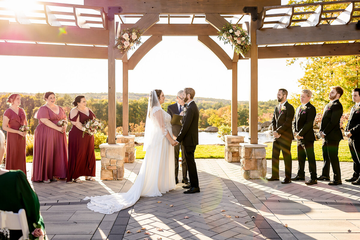 bride and groom holding hands during wedding ceremony at NH wedding venue Pembroke Pines Country Club