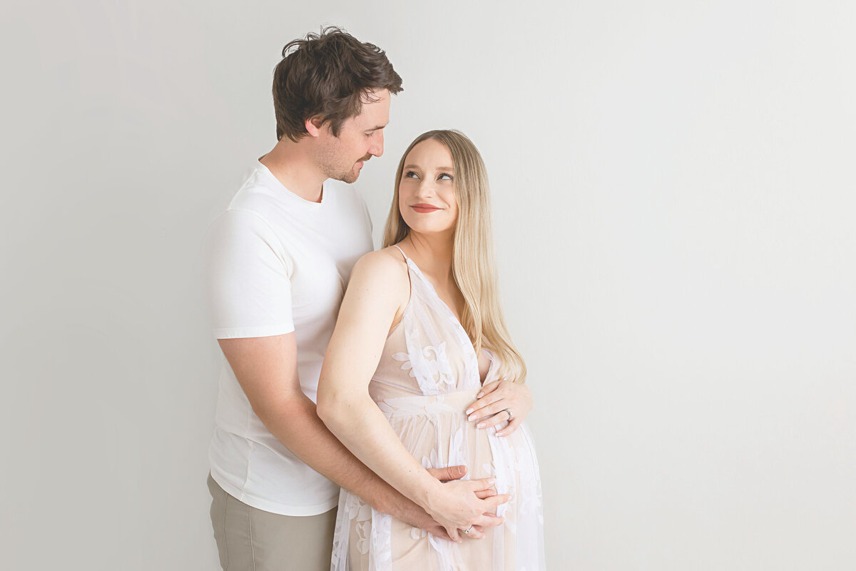 woman and man hand on womans belly