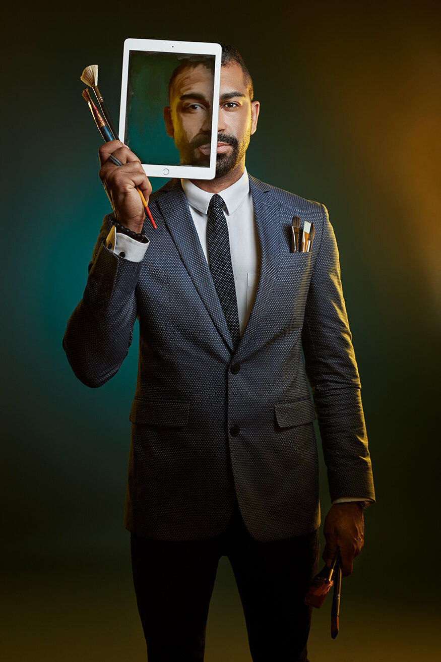 Ken Forbes holding an iPad in a corporate portrait with a sleek backdrop, photographed by Ylva Erevall.