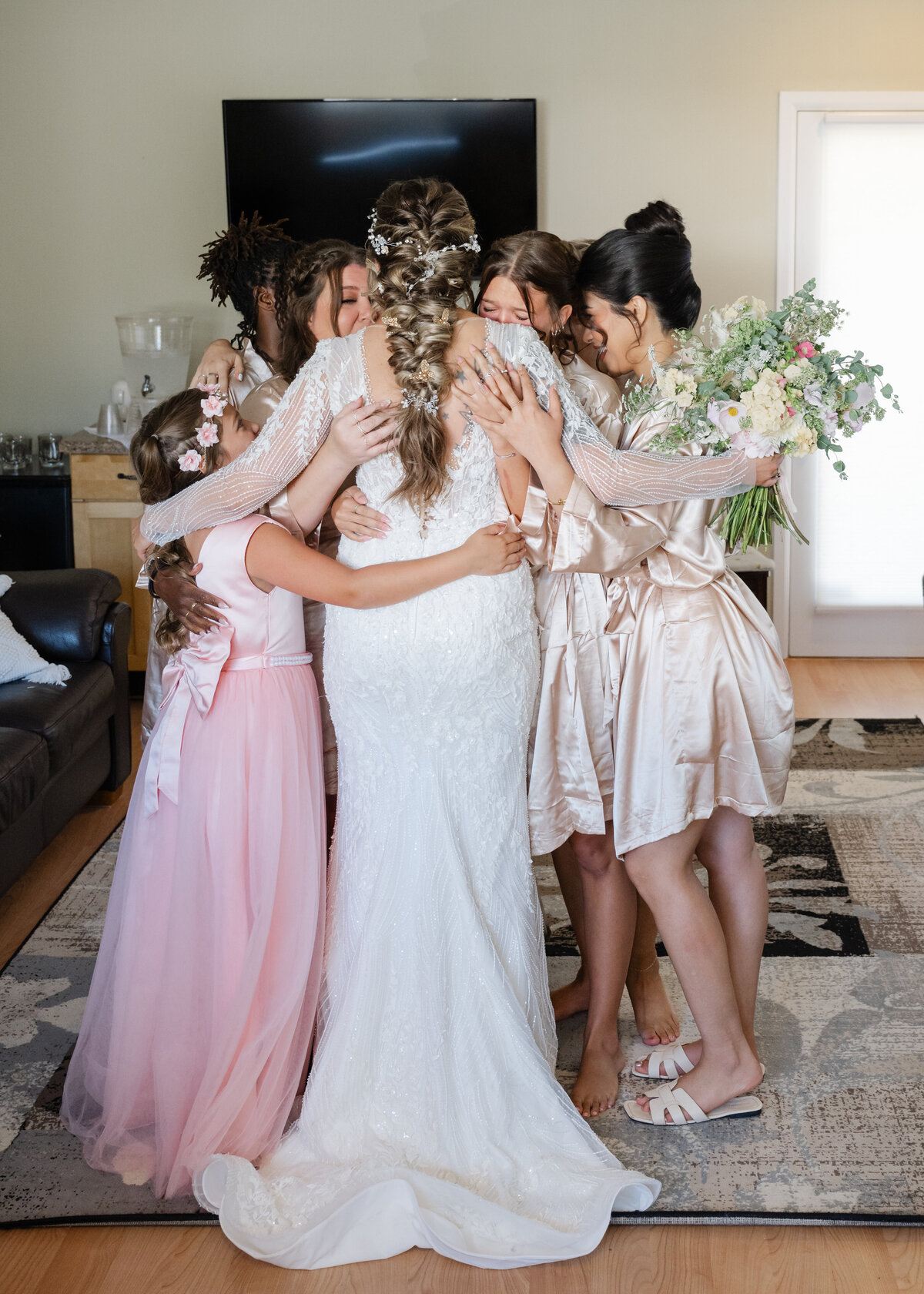 bridal party hug in bridal suite getting ready for wedding