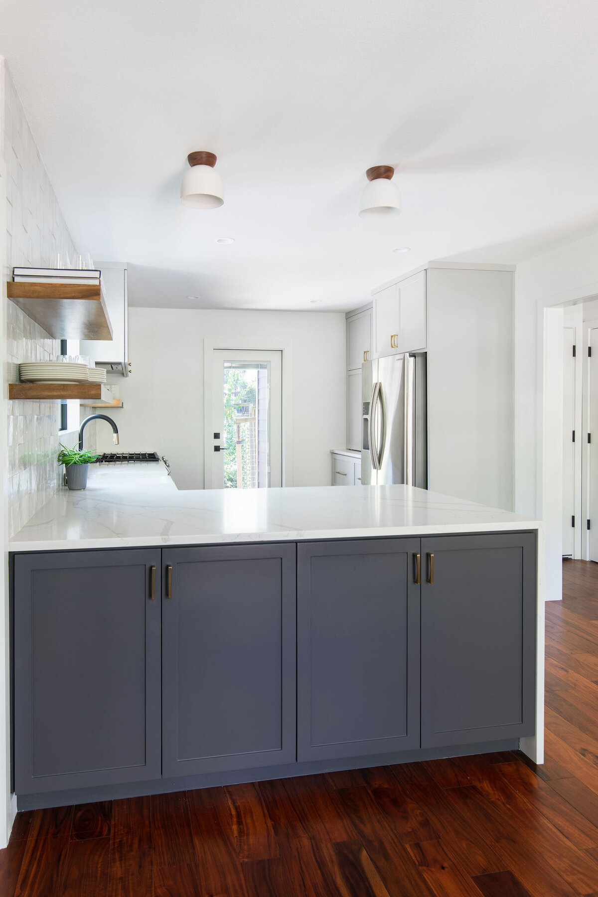 hello-home-two-tone-cabinets-kitchen-remodel-hardwood-flooring-waterfall-peninsula-zellige-backsplash-austin-7