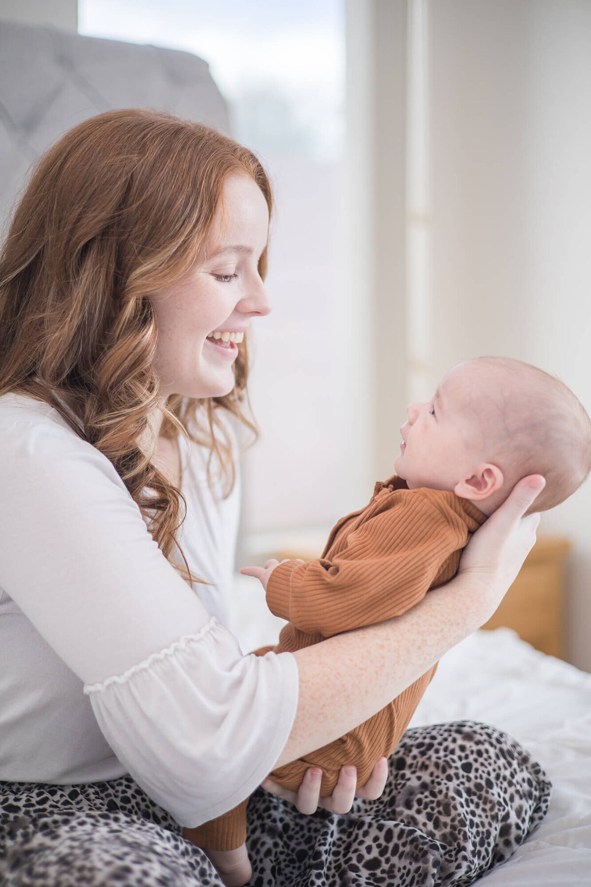 mom playfully talking to her infant son during their Las vegas newborn photography session