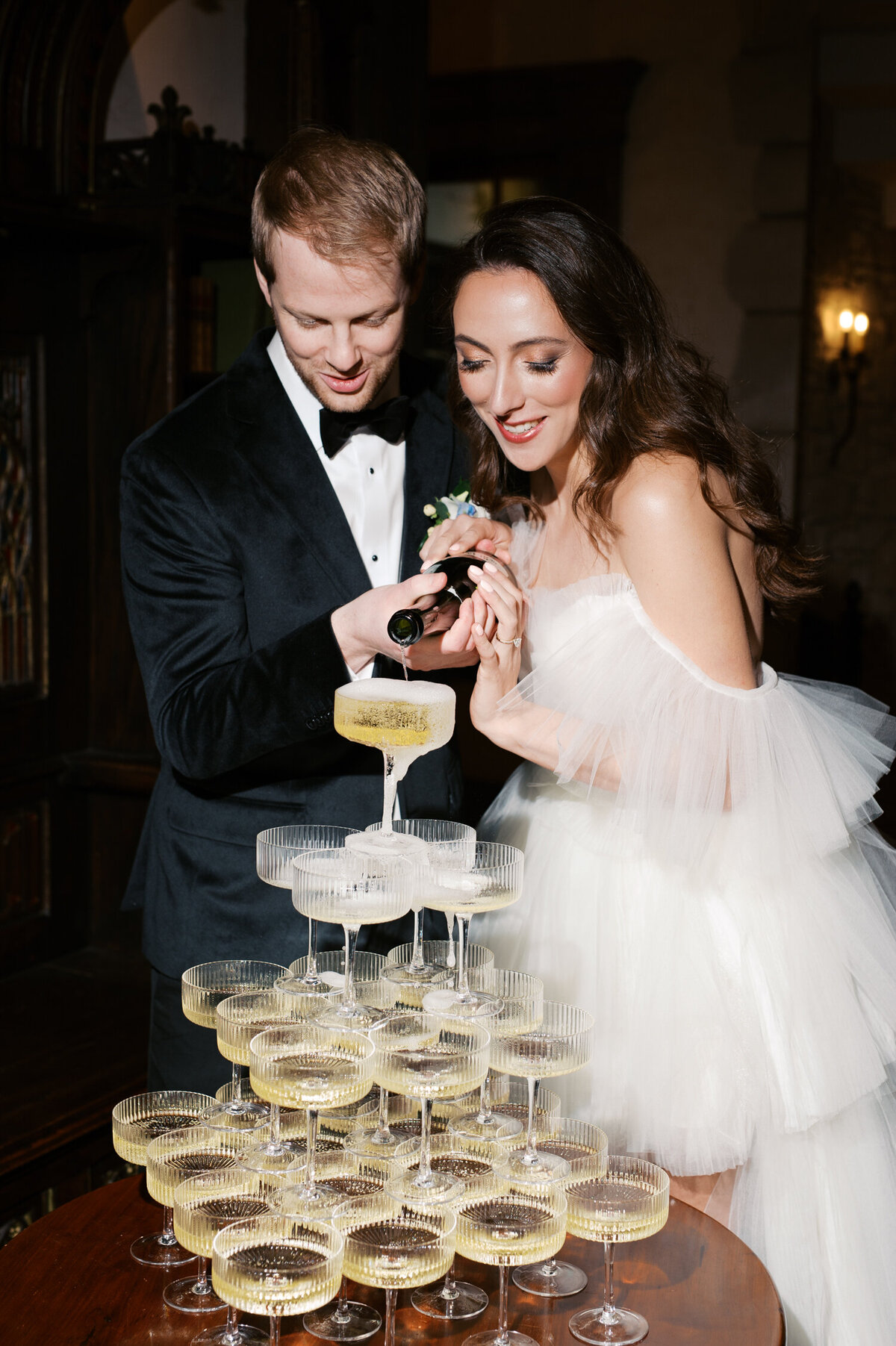 luxury bride and groom during champagne tower at chateau de lis