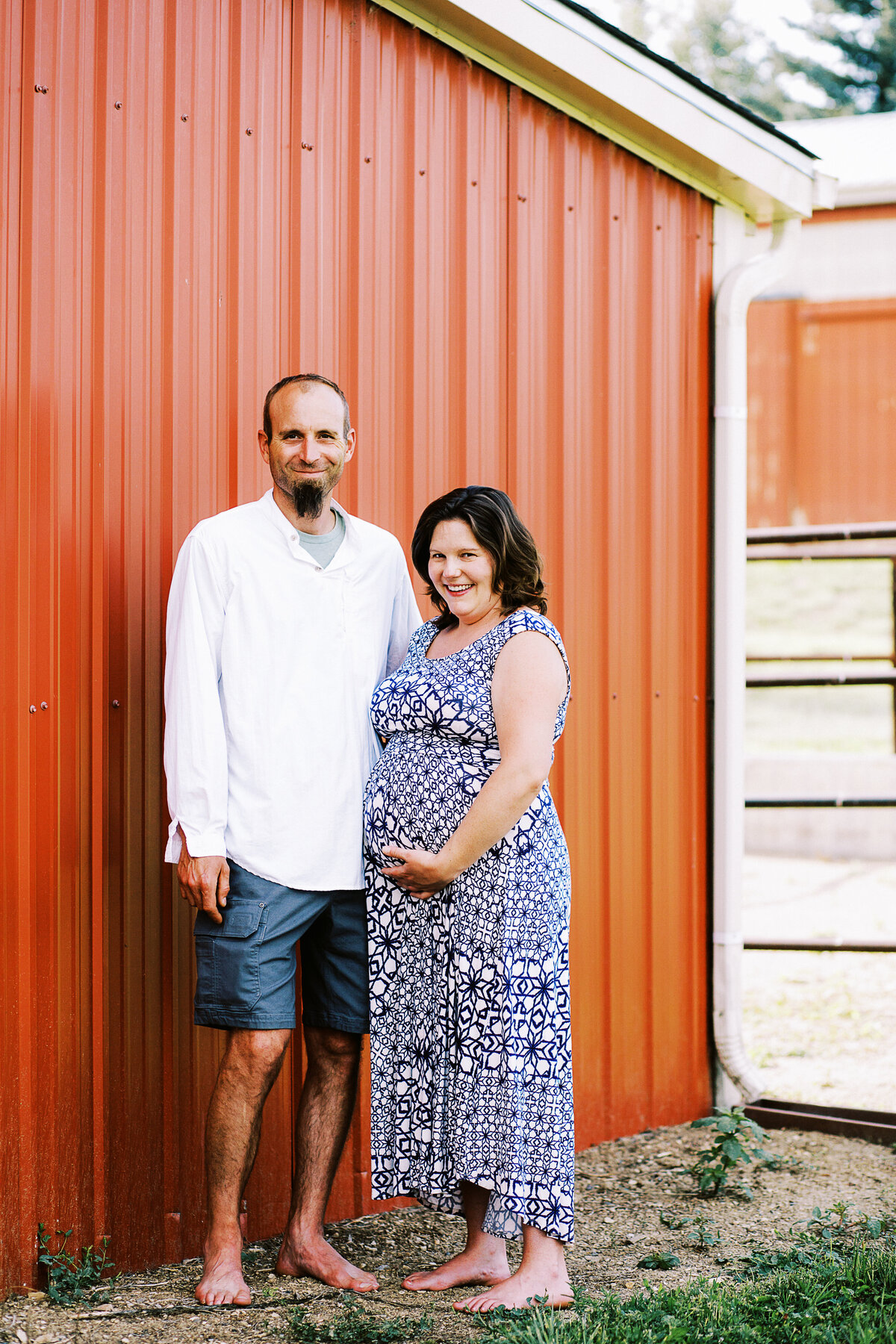 berthoud husband and wife stand by barn