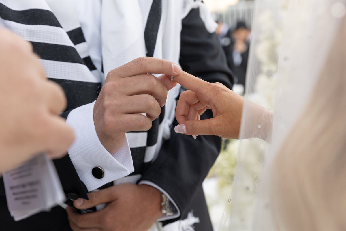 A person pulling a ring off of a person's finger