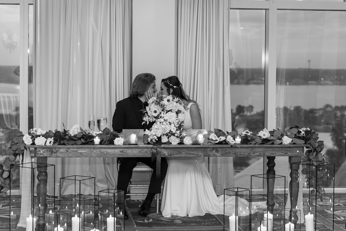 bride and groom kissing at their sweetheart table