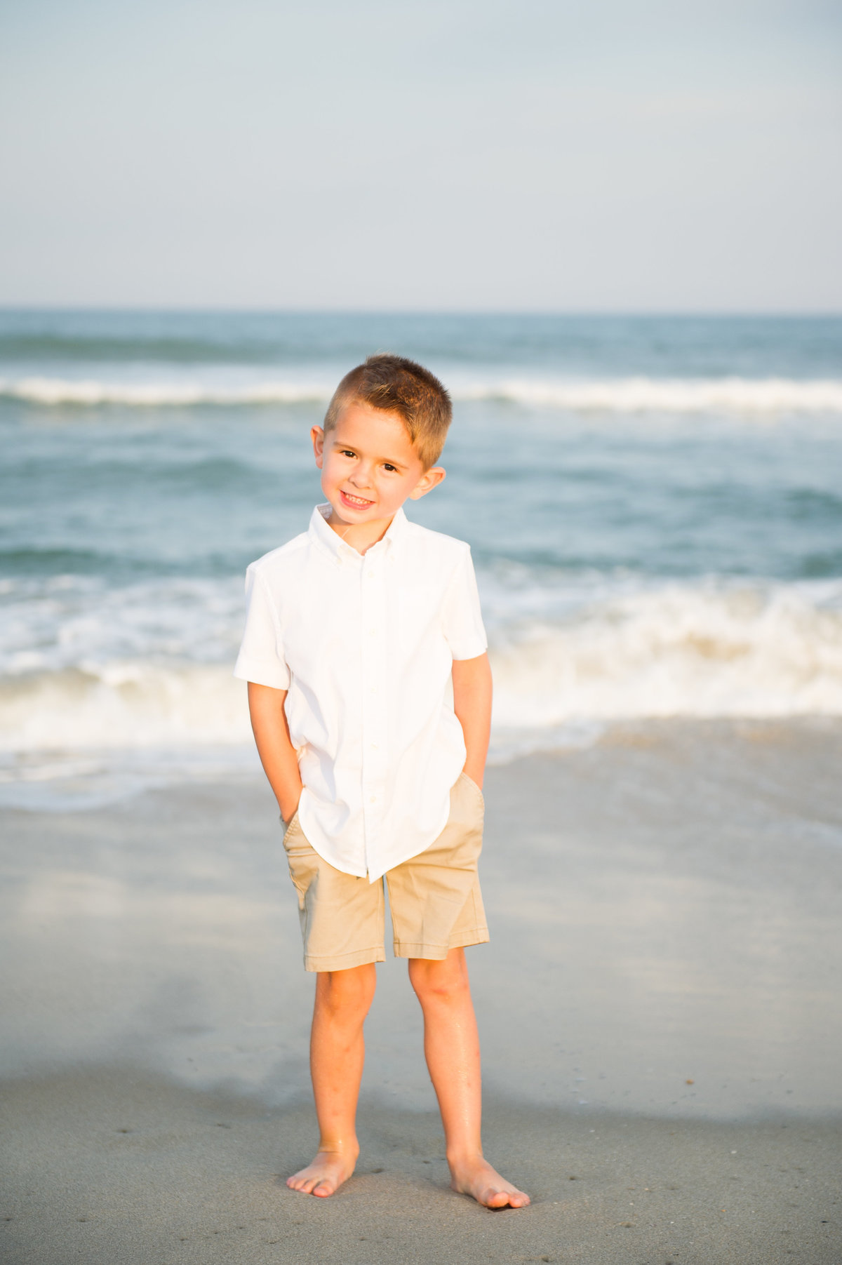 little boy at beach smiles