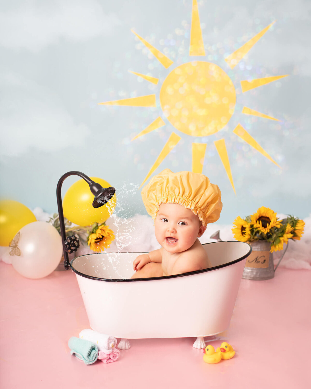 Cake smash and splash photoshoot in LA, baby wearing a shower cap and laughing - By Los Angeles Newborn Photographer