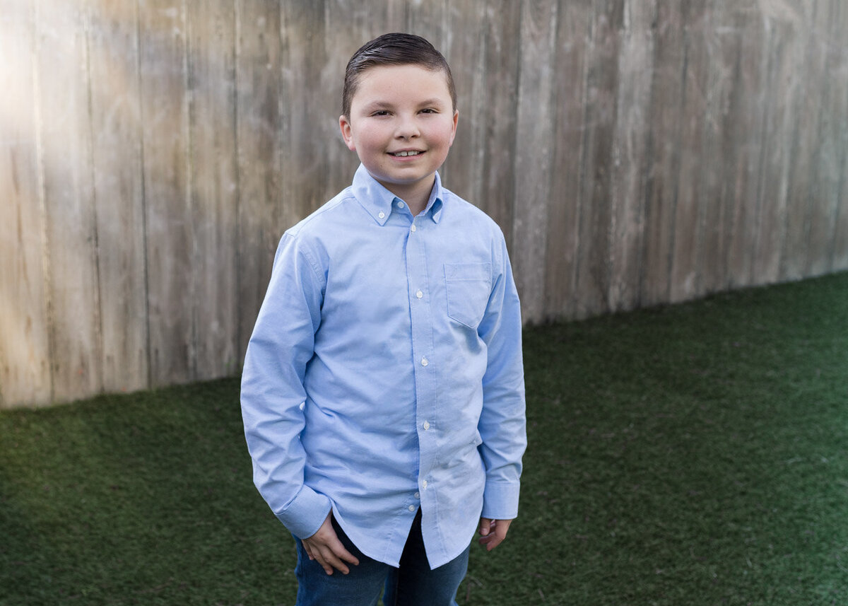 boy outside in blue button up