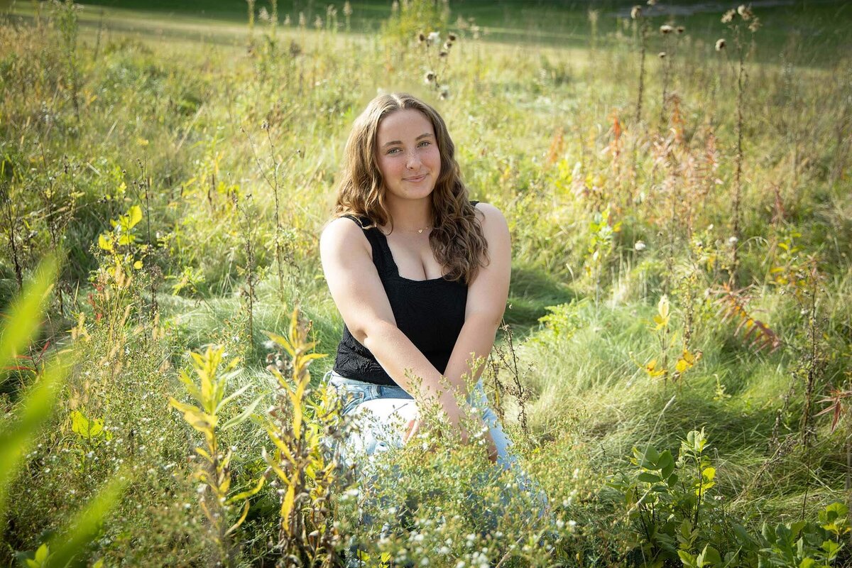 senior-girl-seated-in-field-summer