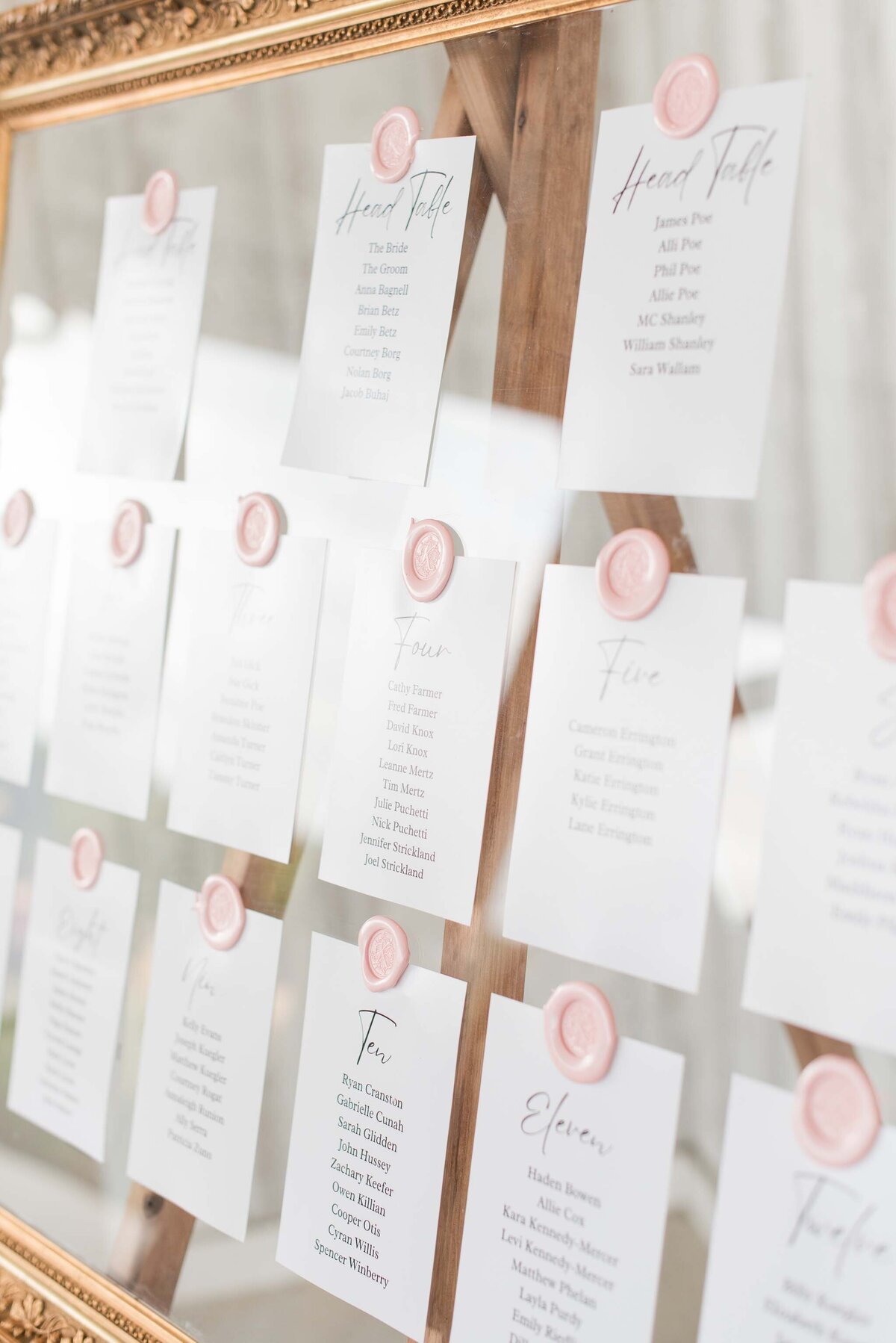 seating chart with pink wax seals and gold mirror