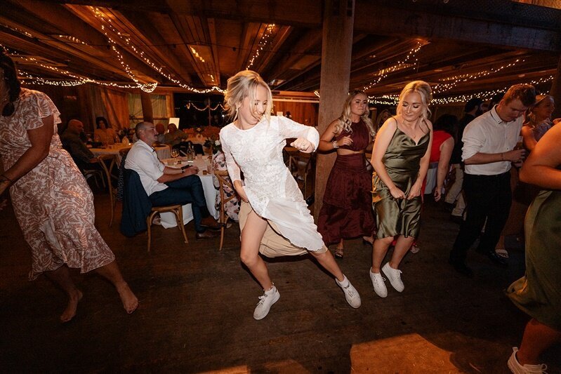 Experience pure joy and unforgettable moments as Maddi twirls and dances with her radiant bridesmaid at their reception party.