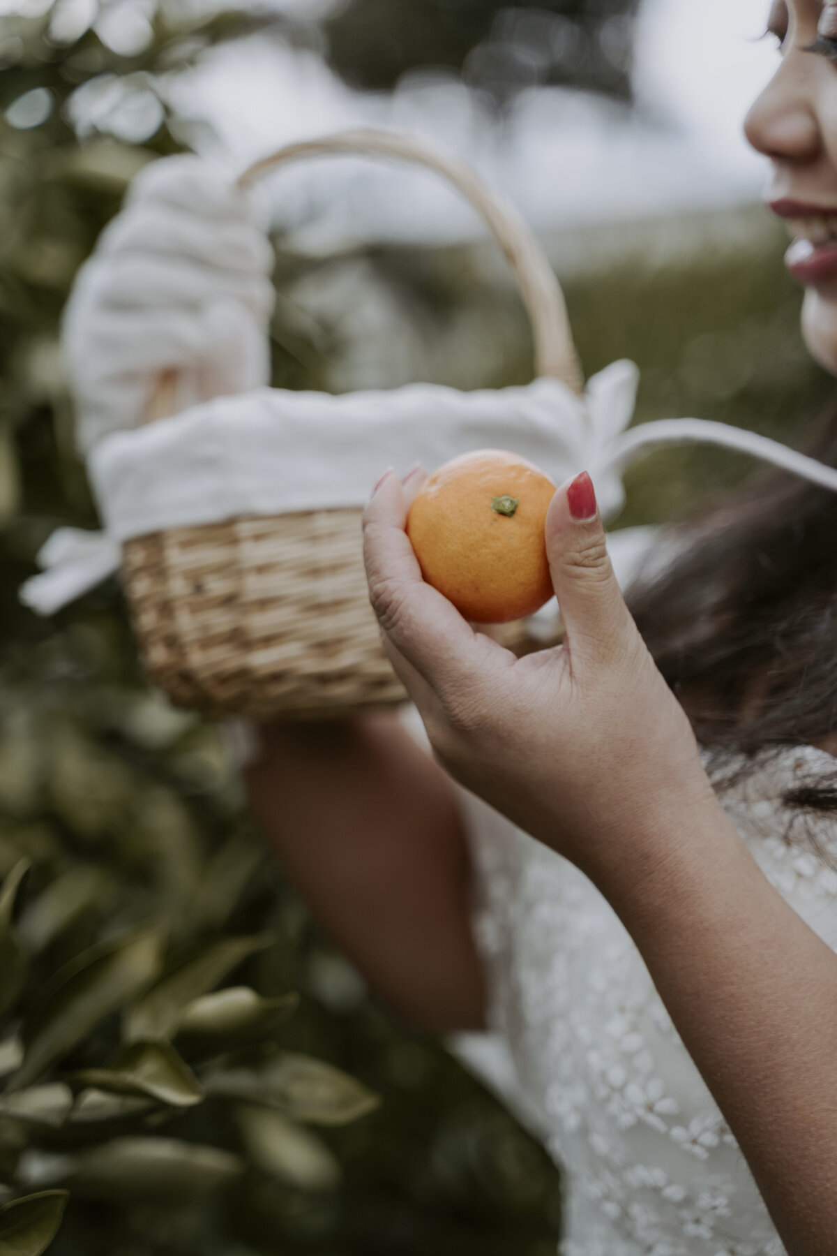 the tangerine and small basket holding by the bride