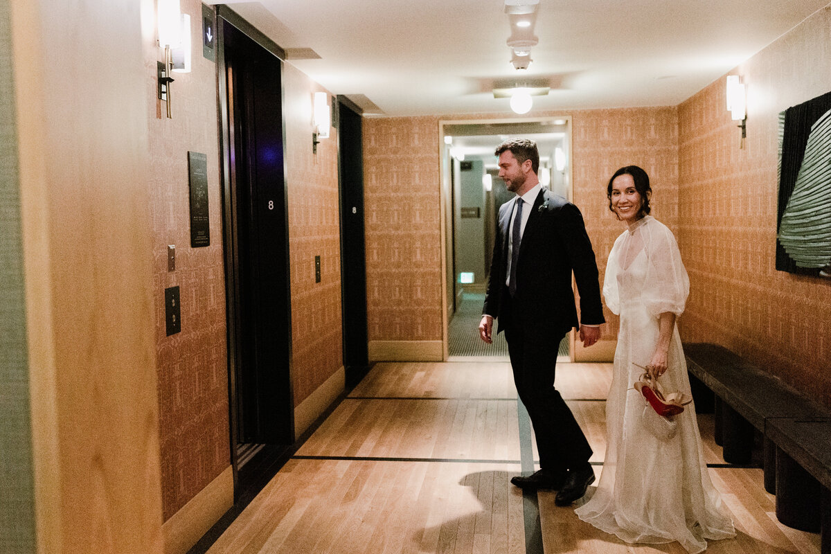 Bride and groom waiting for elevator at Proper hotel Austin