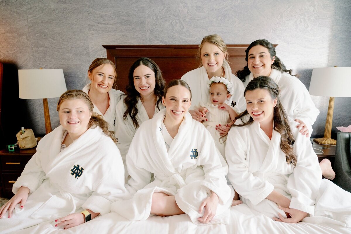 bride and bridesmaids wearing robes on the morning of her wedding