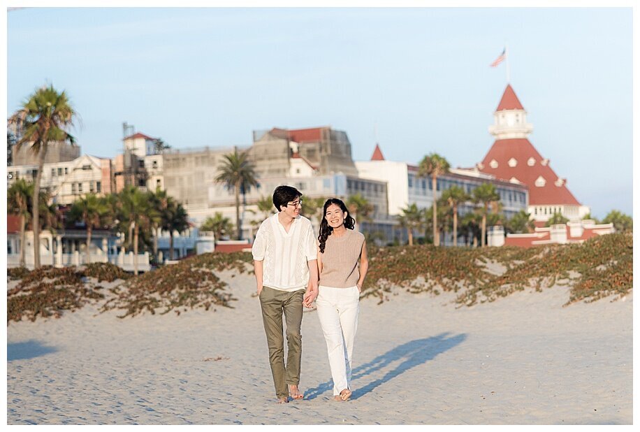 engaged couple walking in front of Hotel del Coronado