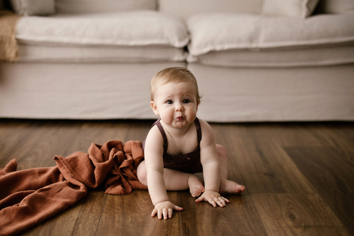 A little baby boy named remy poses for her first birthday milestone baby photoshoot in new plymouth