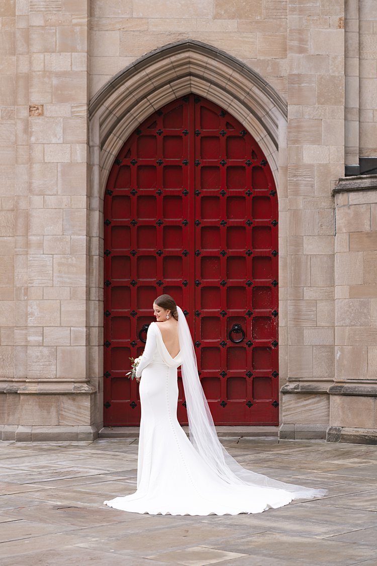 Stylish Bride with long veil in front of red door at Cathedral of Learning Pittsburgh, PA