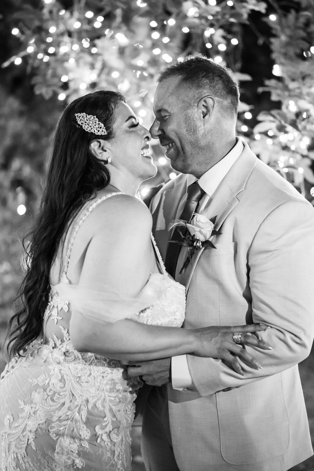 Couple kissing in front of twinkly lights