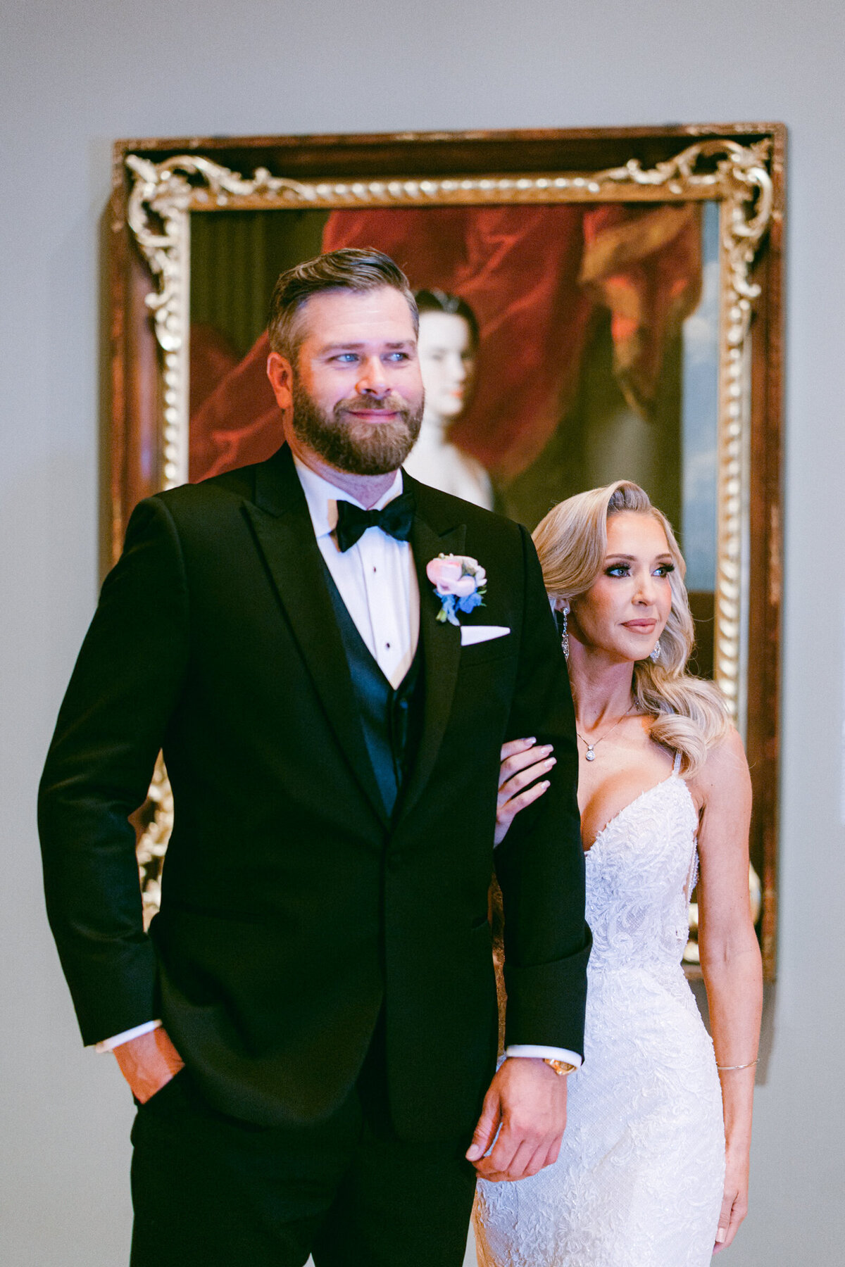 A wedding day photo  of the bride and groom posing for a portrait in Crystal Bridges Museum of American Art in Arkansas