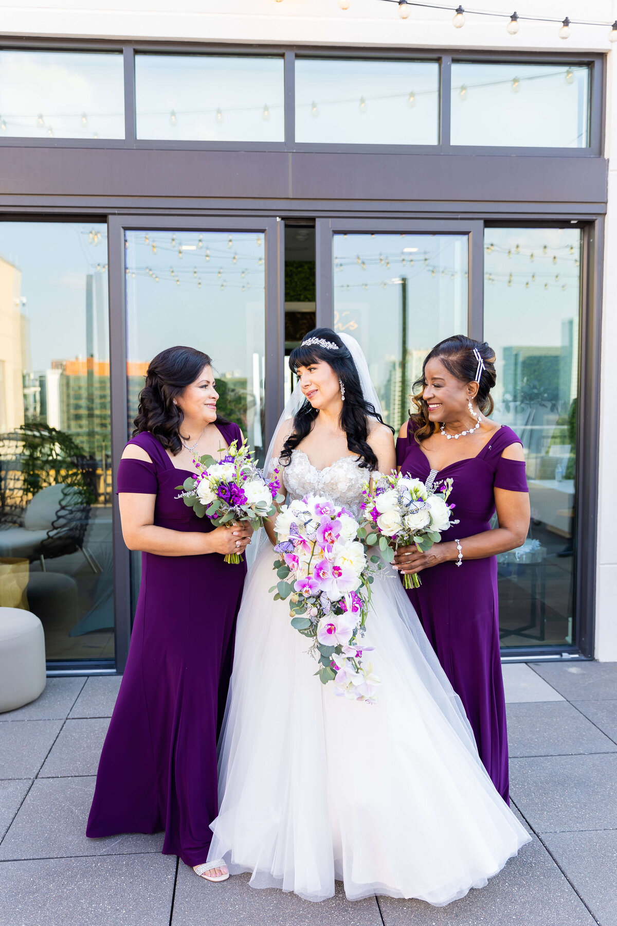 Bride with bridesmaids in purple dresses at The Aertson hotel, Nashville