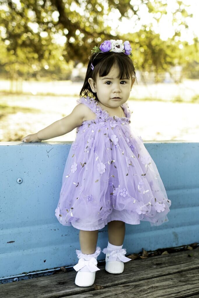 Birthday child playfully twirling in their birthday outfit, enjoying a fun, carefree moment during their photoshoot
