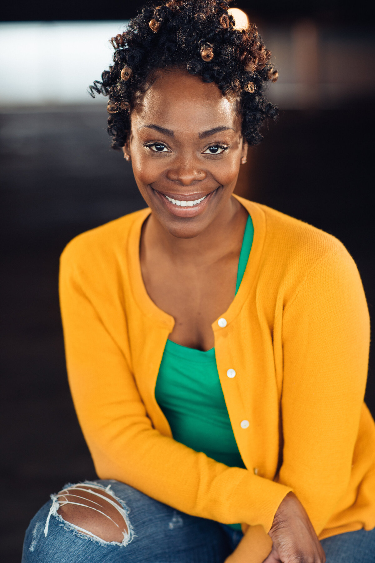 Headshot Photograph Of Young Woman In Outer Yellow Cardigan And Inner Green Tank Top Los Angeles