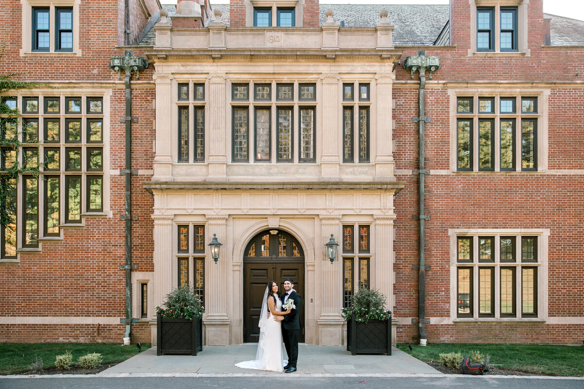 bride and groom in front of pendry natirar mansion