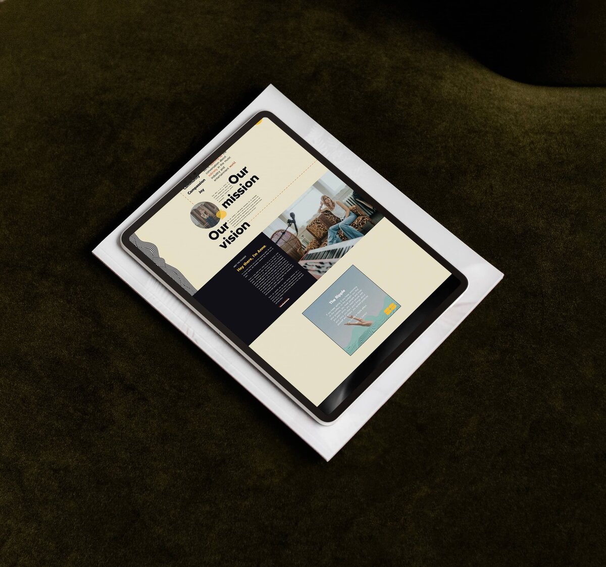 A tablet displaying a website with sections titled "Our mission" and "Our vision" is placed on top of a white document on a dark green surface. This sleek setup highlights the seamless integration of brand identity design services.