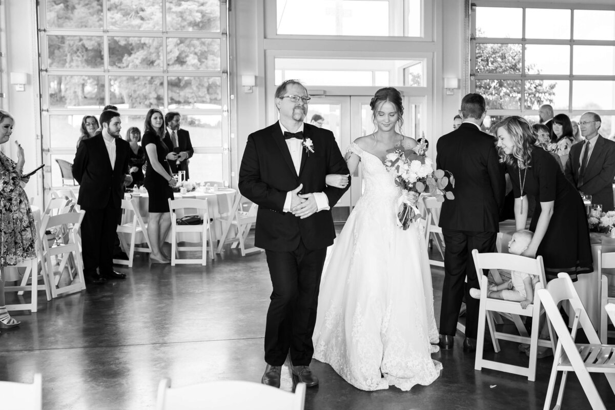 Bride walking down the aisle at the Ruby Cora wedding venue in Adams,,TN