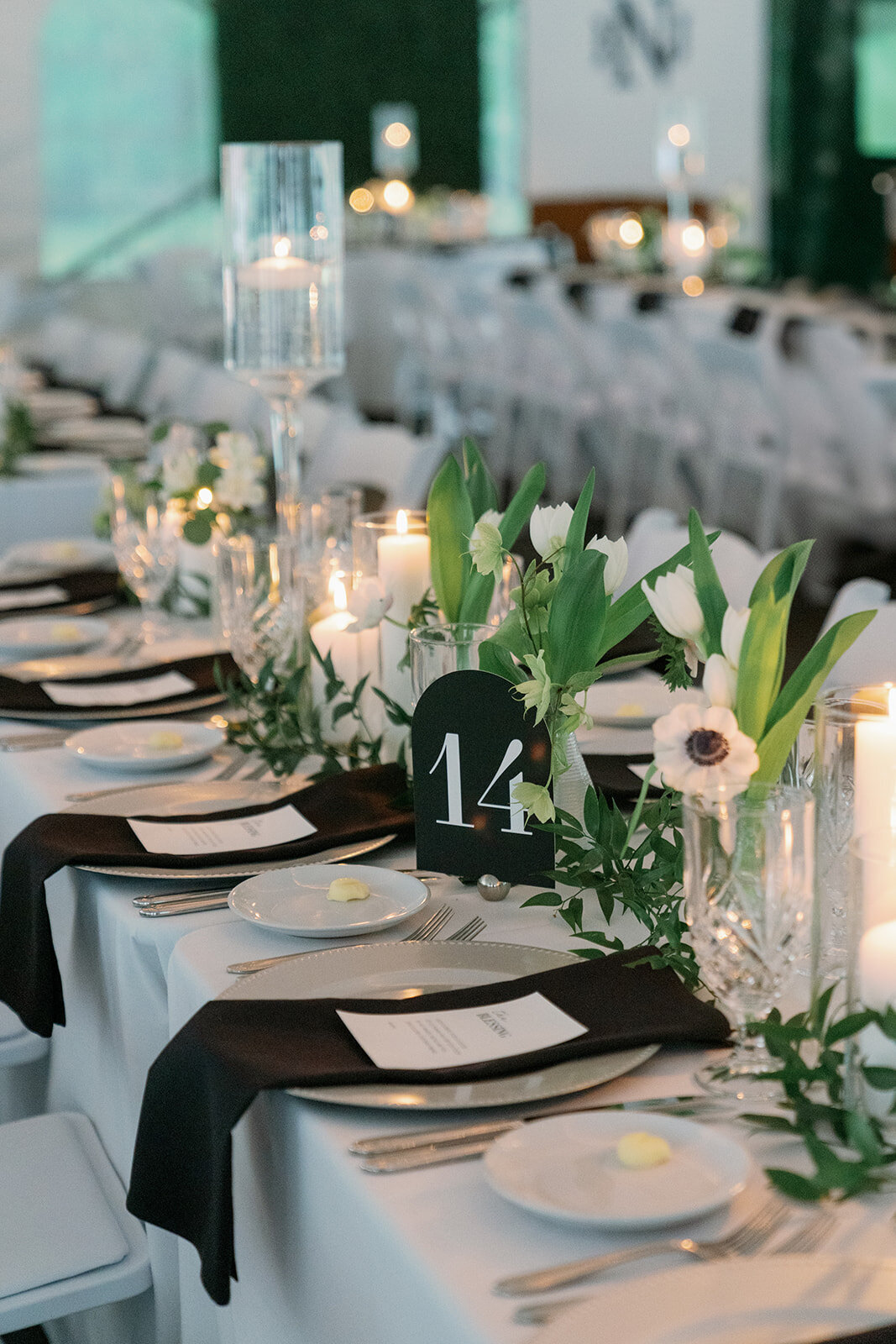Wedding table number 14 with white flowers and greenery at The Morris Estate tented reception.