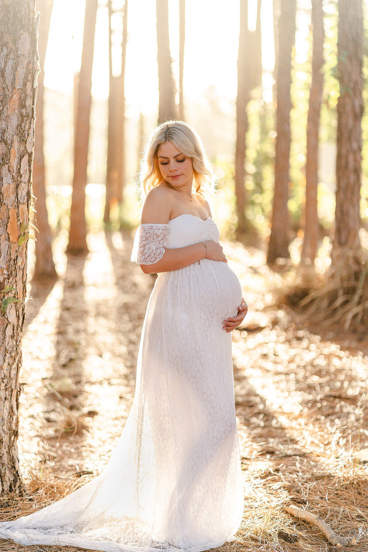magical golden hour portrait in pine forest of belly bump